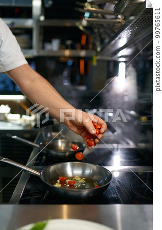 Master chef preparing tomato sauce for pasta in frying pan 99765611