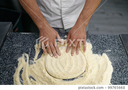Midsection of man chef preparing food at professional kitchen 99765668