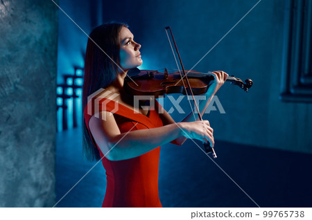 Portrait of gorgeous woman violinist playing beautiful music Portrait of gorgeous woman violinist playing beautiful music 99765738