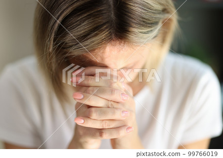 Praying woman folded hands, tilting head and prays Praying woman folded hands, tilting head and prays 99766019