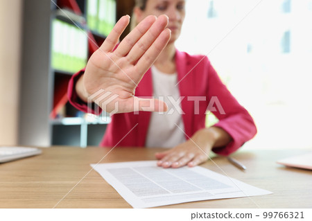 Woman showing stop sign or protesting gesture Woman showing stop sign or protesting gesture 99766321