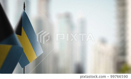 Small flags of the Bahamas on an abstract blurry background 99766590
