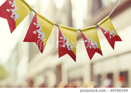 A garland of Bhutan national flags on an abstract blurred background 99766594