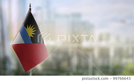 Small flags of the Antigua and Barbuda on an abstract blurry background 99766643