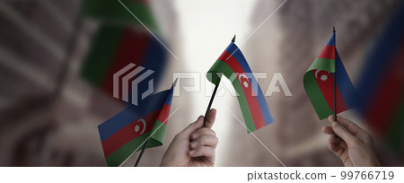 A group of people holding small flags of the Azerbaijan in their hands A group of people holding small flags of the Azerbaijan in their hands 99766719