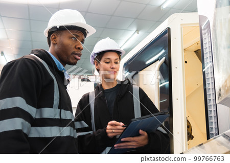 Engineer working in robotics factory Engineer working in robotics factory 99766763