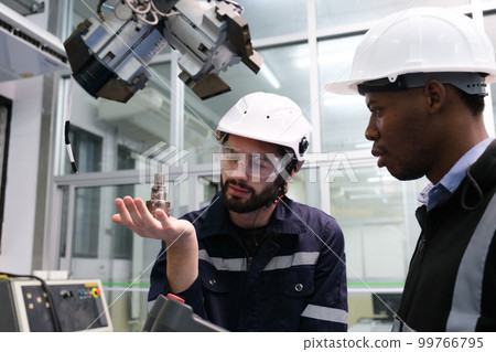 Engineer working in robotics factory Engineer working in robotics factory 99766795
