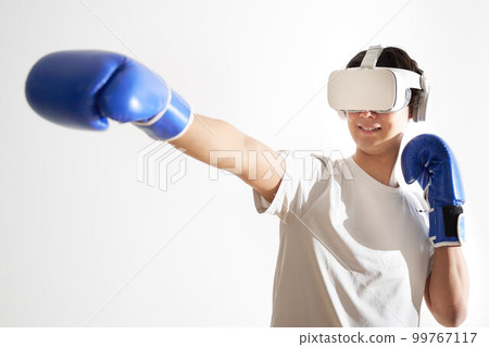 Young man wearing VR goggles and boxing 99767117