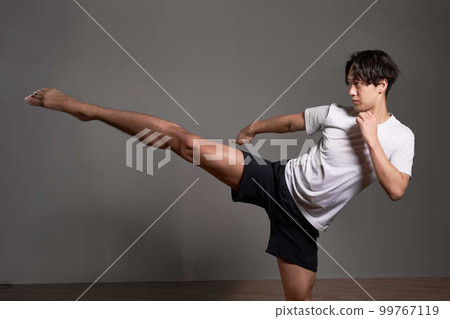 Young man doing kickboxing training boxercise image Young man doing kickboxing training boxercise image 99767119