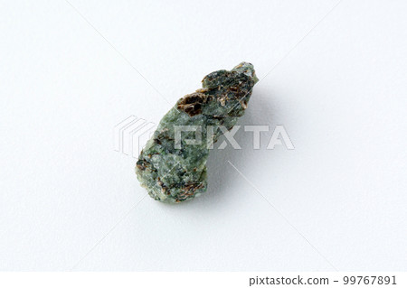 Natural chrysolite, olivine green color transparent raw crystal, close up, white background Natural chrysolite, olivine green color transparent raw crystal, close up, white background 99767891