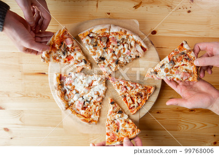 three people taking slices of pizza out of the box. fast delivery of food. packaging for fast food. top view 99768006