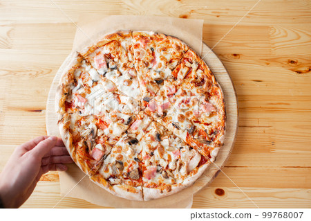 one people taking slices of pizza out of the box. fast delivery of food. packaging for fast food. top view one people taking slices of pizza out of the box. fast delivery of food. packaging for fast food. top view 99768007