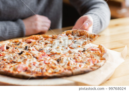 one people taking slices of pizza out of the box. fast delivery of food. packaging for fast food. top view 99768024