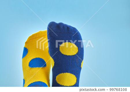 World Down syndrome day background. Legs with different socks as symbol of down syndrome World Down syndrome day background. Legs with different socks as symbol of down syndrome 99768108