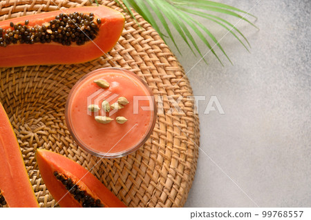 Pineapple lassi in glass on gray background. 99768557