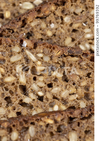 Black rye bread cut into chunks with sunflower seeds 99769392