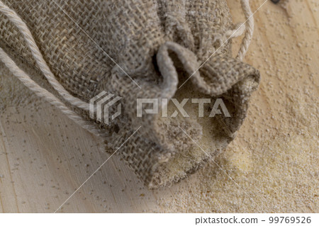 Semolina poured into a cotton bag ready for cooking Semolina poured into a cotton bag ready for cooking 99769526