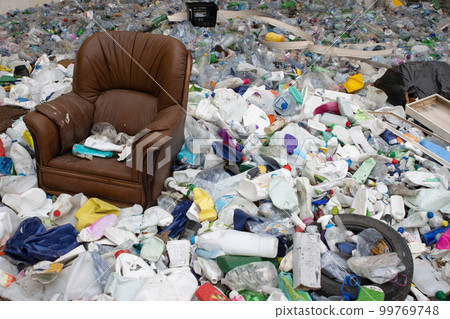 Old leather chair and plastic garbage in a landfill - a problem of environmental pollution Old leather chair and plastic garbage in a landfill - a problem of environmental pollution 99769748