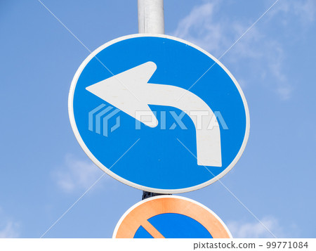 Road sign (regulatory sign) ``Do not proceed outside the designated direction'' and blue sky. Road sign (regulatory sign) ``Do not proceed outside the designated direction'' and blue sky. 99771084