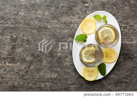 Healthy breakfast or morning with chia seeds lemon and mint on table background, vegetarian food, diet and health concept. Chia pudding with lemon and mint 99771663