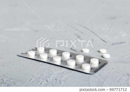 Blister package with aspirin on color background. Medicine pills on a light background. Medicines and prescription pills flat lay background. white medical tablets in blister 99771712