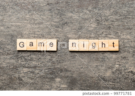 Game Night word written on wood block. Game Night text on cement table for your desing, concept Game Night word written on wood block. Game Night text on cement table for your desing, concept 99771781