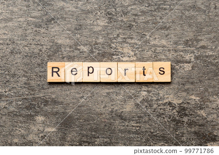 REPORTS word written on wood block. REPORTS text on table, concept 99771786