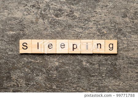 SLEEPING word written on wood block. SLEEPING text on cement table for your desing, concept 99771788