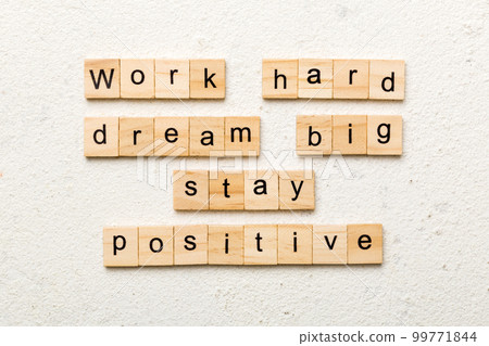 Work hard dream big stay positive word written on wood block. Work hard dream big stay positive text on cement table for your desing, Top view concept Work hard dream big stay positive word written on wood block. Work hard dream big stay positive text on cement table for your desing, Top view concept 99771844