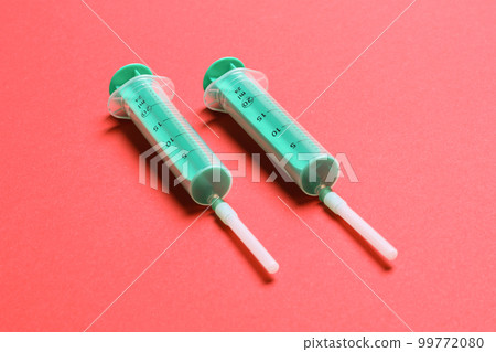 Top view of medical syringes on colorful background with copy space. Injection equipment concept Top view of medical syringes on colorful background with copy space. Injection equipment concept 99772080