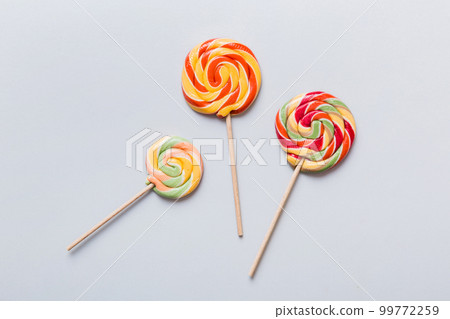 Set of colorful lollipops on colored background. Summer concept. Party Happy Birthday or Minimalist Concept Set of colorful lollipops on colored background. Summer concept. Party Happy Birthday or Minimalist Concept 99772259