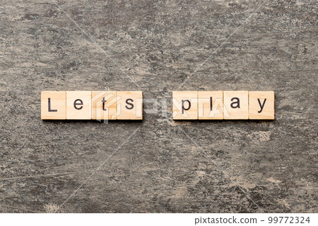 lets play word written on wood block. lets play text on cement table for your desing, concept lets play word written on wood block. lets play text on cement table for your desing, concept 99772324