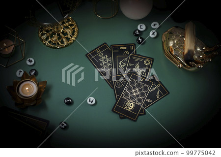 Tarot card reader arranges cards in a card spread. Fortune-telling concept Tarot card reader arranges cards in a card spread. Fortune-telling concept 99775042