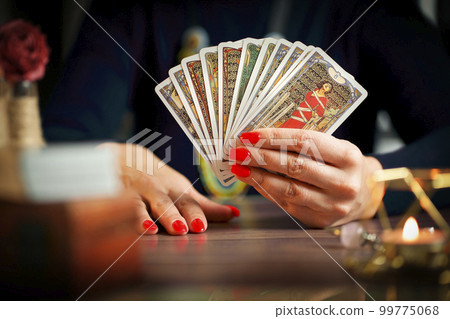Blurred tarot cards on the table, esoteric concept, fortune telling predictions Blurred tarot cards on the table, esoteric concept, fortune telling predictions 99775068