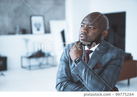 Chief Financial Officer of a Large Company is Thinking How to Deal with the Crisis During the Pandemic. Man Plans to Improve his Business Strategies. Close-Up Portrait. Interior Background. High 99775284
