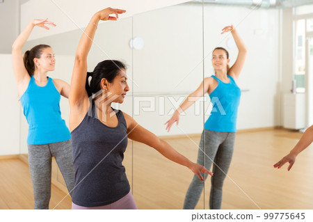 Group of smiling women training sport dance Group of smiling women training sport dance 99775645