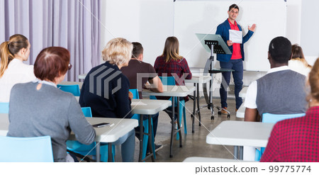 Students with teacher studying in classroom Students with teacher studying in classroom 99775774