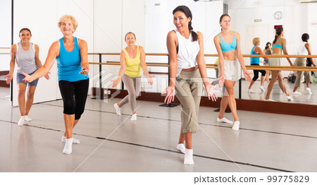 Various aged women dancing modern dance 99775829