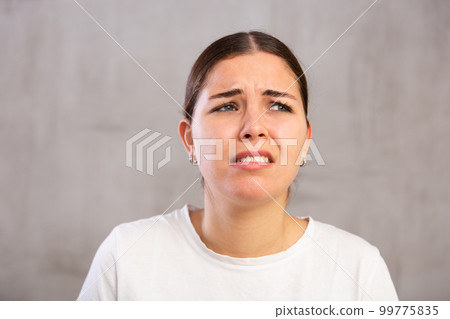 Close-up portrait of young woman with sad expression on face 99775835