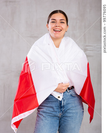 Happy girl stands with flag of Poland. Isolated on gray background 99776095