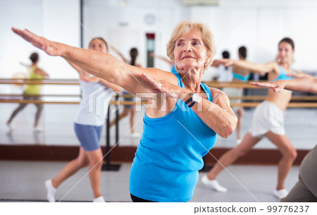 Portrait of an mature European woman enjoying energetic dancing in the studio 99776237