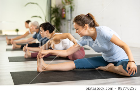 Group of different aged women stretching Group of different aged women stretching 99776253