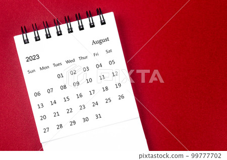 A August 2023 calendar desk for the organizer to plan and reminder on dark red color background. A August 2023 calendar desk for the organizer to plan and reminder on dark red color background. 99777702