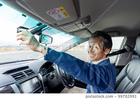 Senior driver checking drive recorder 99782091