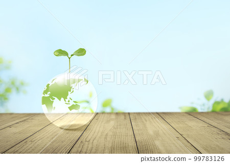 Sprouts on transparent earth against the blue sky. Environmental protection and sustainable society Sprouts on transparent earth against the blue sky. Environmental protection and sustainable society 99783126