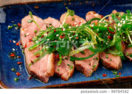 Sliced tataki roast duck breast with seaweed chuka Sliced tataki roast duck breast with seaweed chuka 99784582