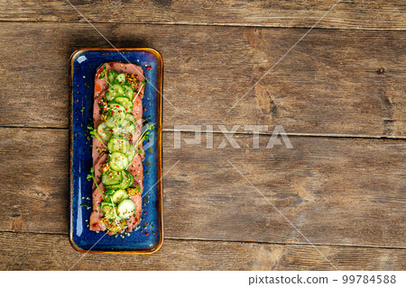 Sliced tataki roast beef tongue with seaweed chuka Sliced tataki roast beef tongue with seaweed chuka 99784588