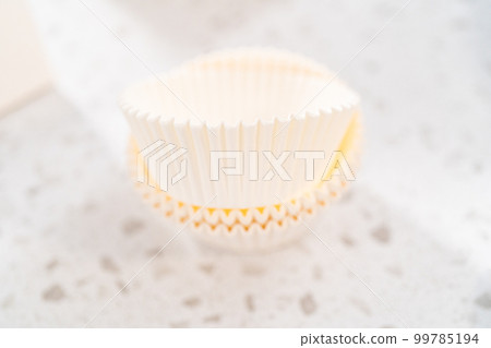 Packaging homemade chocolate fudge with peanut butter swirl into a white gift box. 99785194