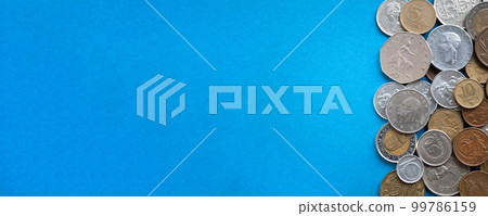 Coins of world's countries on blue backgrouns, banner. International money or numismatics concept 99786159