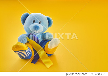 World Down Syndrome day background.Teddy bear with different socks on yellow background. World Down Syndrome day background.Teddy bear with different socks on yellow background. 99788333